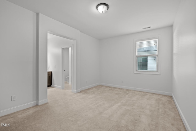 empty room with carpet floors and baseboards