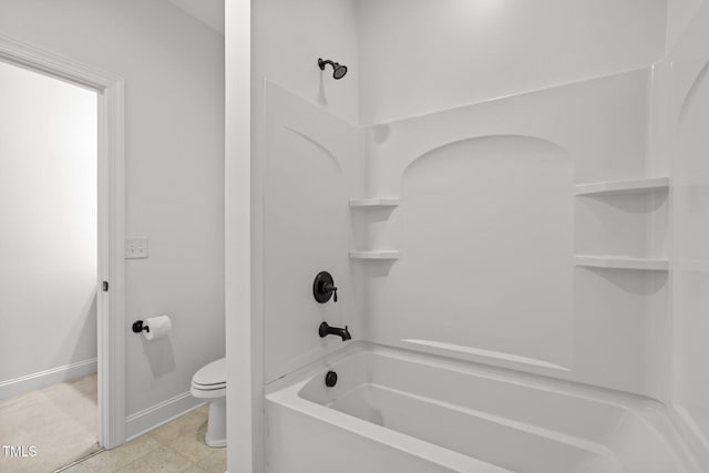 bathroom with shower / washtub combination, toilet, and baseboards