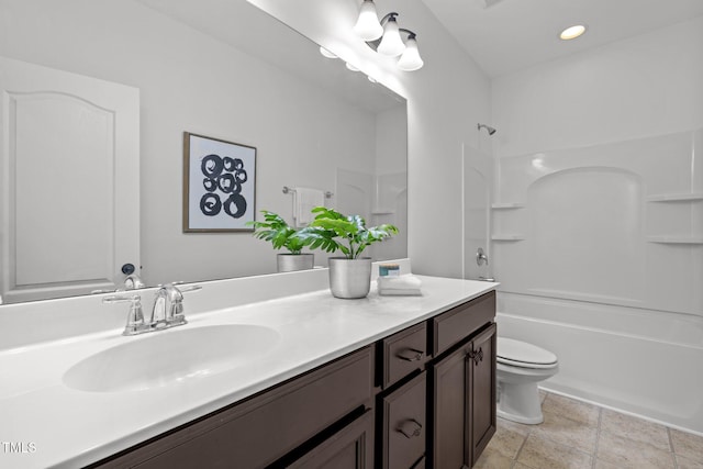 full bathroom featuring washtub / shower combination, vanity, toilet, recessed lighting, and stone finish flooring