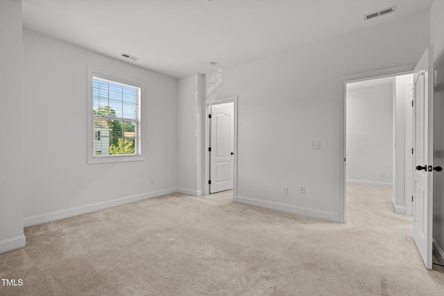 unfurnished bedroom with light colored carpet and baseboards