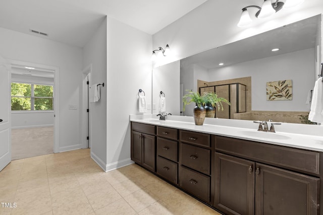 full bath featuring tile patterned flooring, a stall shower, double vanity, baseboards, and recessed lighting