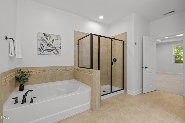 full bath with a bath, a shower stall, recessed lighting, and tile patterned flooring