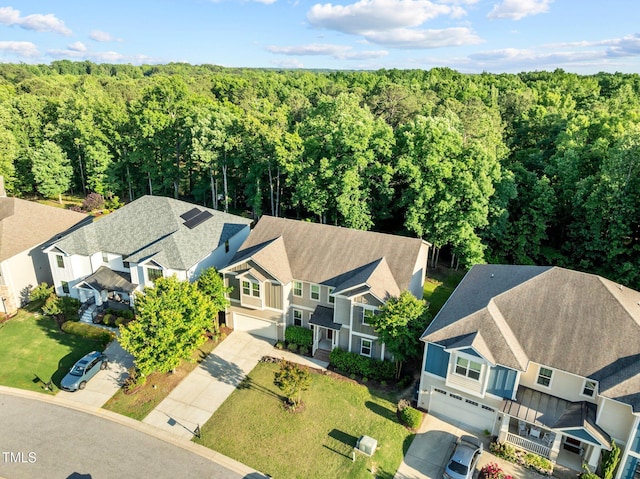 aerial view of residential area with a heavily wooded area