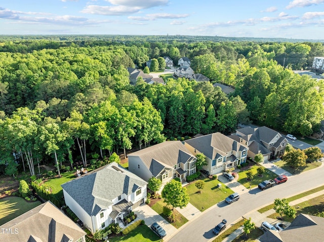 aerial perspective of suburban area featuring a forest