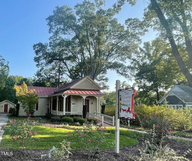 view of front facade with a porch, a standing seam roof, and metal roof