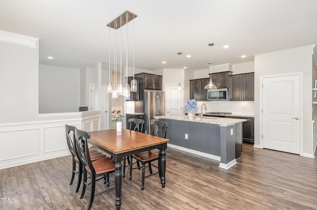 3360 Bordwell Ridge Dr, New Hill, NC 27562 - dining space featuring a chandelier, dark wood-style flooring, wainscoting, and recessed lighting
