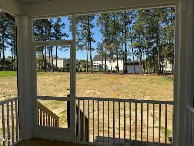 unfurnished sunroom featuring a residential view