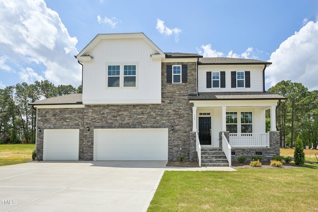 view of front of property featuring covered porch, stone siding, driveway, and a front lawn