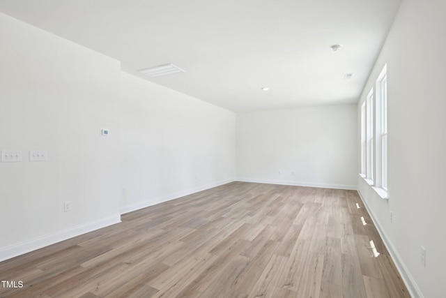 unfurnished room featuring light wood-style floors and baseboards