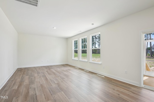 empty room featuring light wood-style floors and baseboards