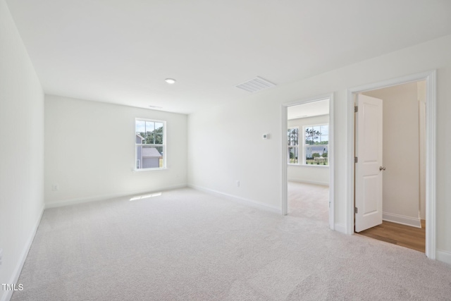 carpeted spare room with healthy amount of natural light, baseboards, and recessed lighting
