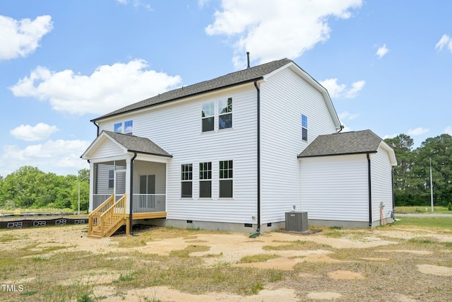 rear view of house featuring crawl space, a sunroom, central air condition unit, and roof with shingles
