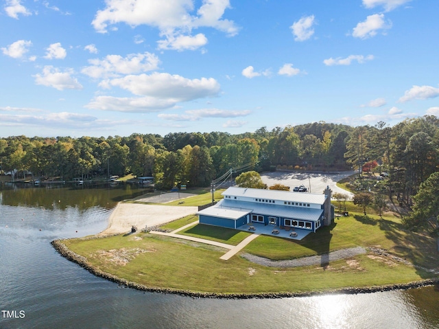 aerial view featuring a forest view and a water view