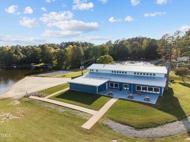 drone / aerial view featuring a water view and a view of trees