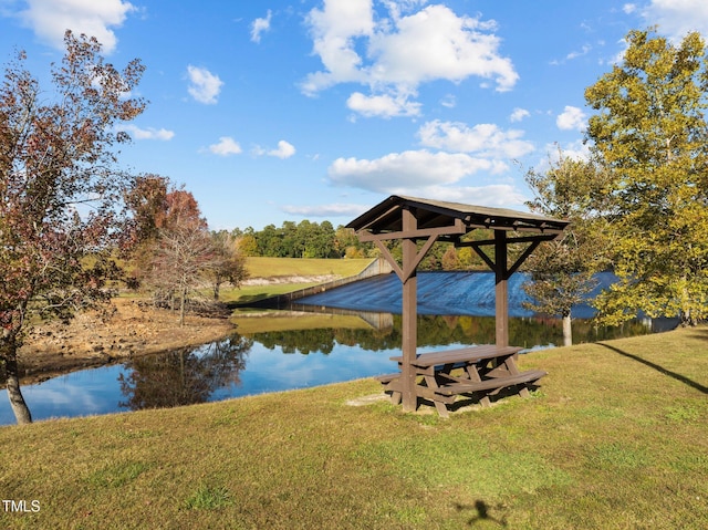 dock area featuring a lawn and a water view