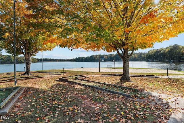 exterior space with a water view and volleyball court