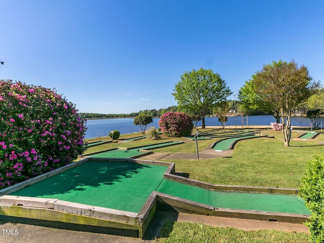 surrounding community with a lawn and a water view