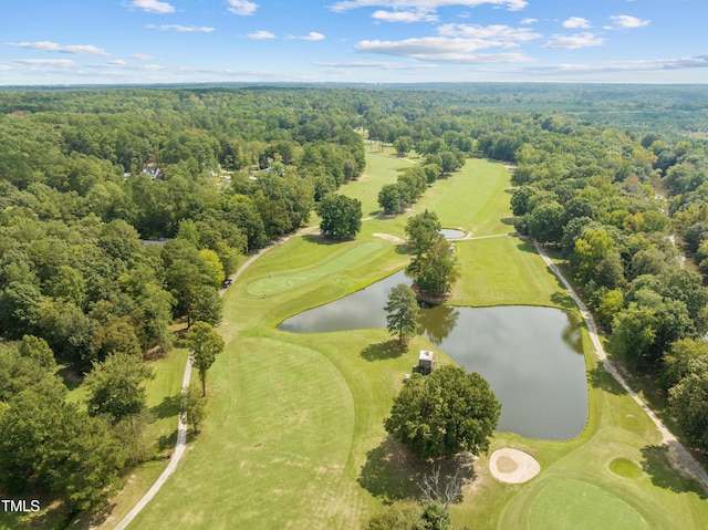 drone / aerial view with a view of trees, golf course view, and a water view