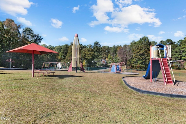 community jungle gym featuring a lawn