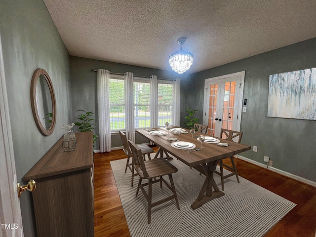 1020 Retriever Ln, Raleigh, NC 27603 - dining space featuring a textured ceiling, french doors, dark wood-style floors, and a chandelier