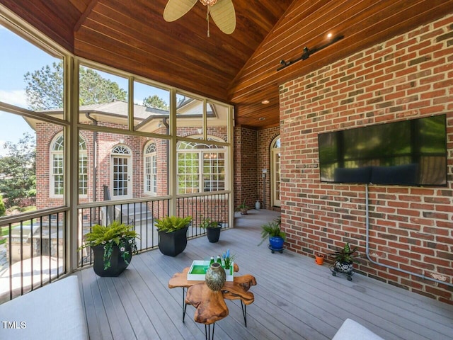 unfurnished sunroom with ceiling fan