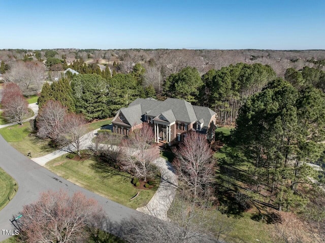 bird's eye view with a wooded view