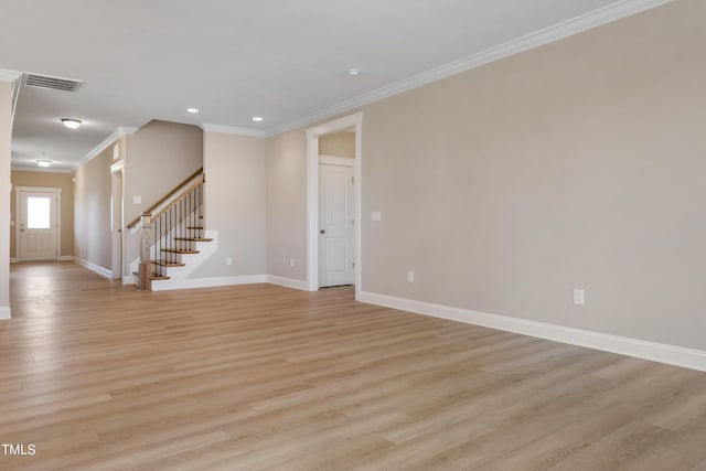 1075 Fairhaven Dr Lot 51, Mebane, NC 27302 - unfurnished living room featuring crown molding, baseboards, stairs, light wood finished floors, and recessed lighting