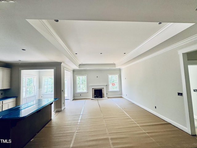 1075 Fairhaven Dr Lot 51, Mebane, NC 27302 - unfurnished living room featuring a tray ceiling, ornamental molding, baseboards, and a fireplace with flush hearth