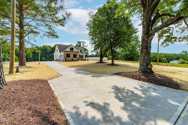 4924 Zebulon Rd, Zebulon, NC 27597 - view of front of home featuring concrete driveway, a front yard, and a garage