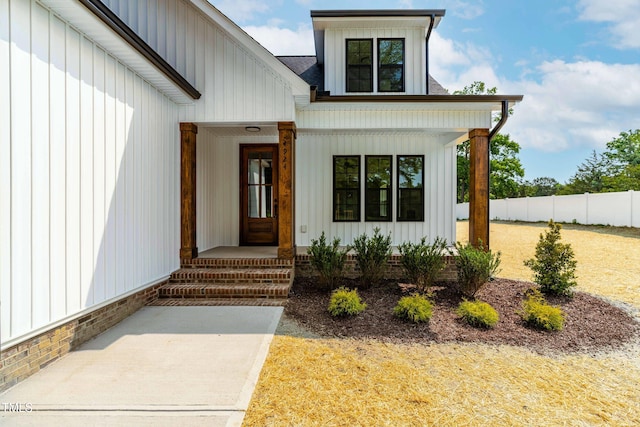 4924 Zebulon Rd, Zebulon, NC 27597 - view of exterior entry featuring board and batten siding, a porch, and a shingled roof