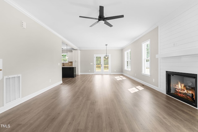 4924 Zebulon Rd, Zebulon, NC 27597 - unfurnished living room with crown molding, a fireplace, a ceiling fan, wood finished floors, and french doors