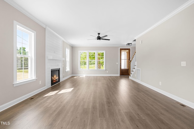 4924 Zebulon Rd, Zebulon, NC 27597 - unfurnished living room with crown molding, ceiling fan, a fireplace, stairs, and wood finished floors
