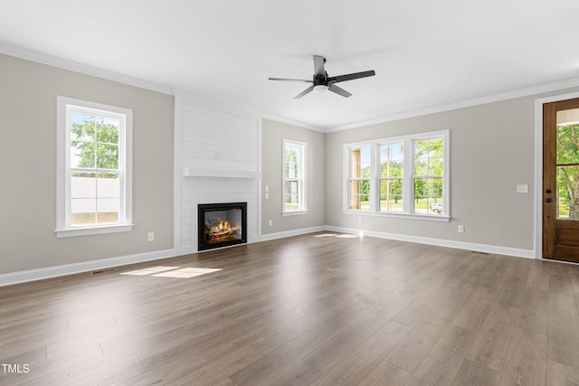 4924 Zebulon Rd, Zebulon, NC 27597 - unfurnished living room featuring healthy amount of natural light, a ceiling fan, ornamental molding, and dark wood finished floors