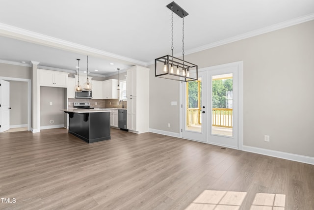 4924 Zebulon Rd, Zebulon, NC 27597 - kitchen featuring stainless steel appliances, a chandelier, open floor plan, white cabinets, and a center island