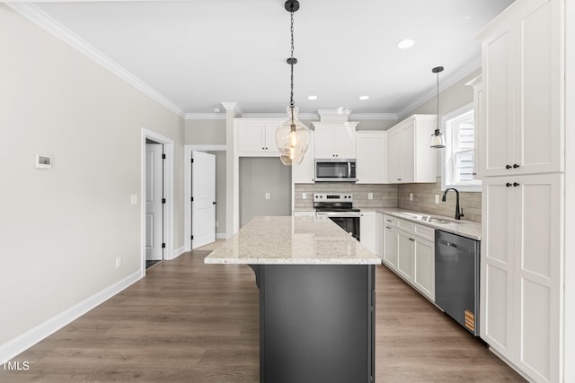 4924 Zebulon Rd, Zebulon, NC 27597 - kitchen featuring appliances with stainless steel finishes, a kitchen island, tasteful backsplash, ornamental molding, and white cabinets
