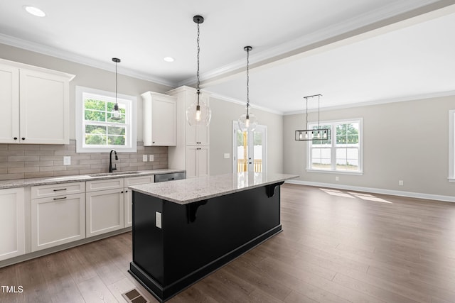 4924 Zebulon Rd, Zebulon, NC 27597 - kitchen featuring recessed lighting, healthy amount of natural light, a center island, backsplash, and white cabinets