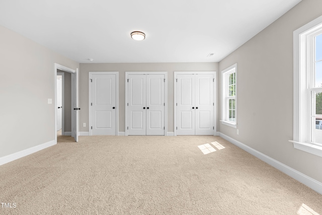 4924 Zebulon Rd, Zebulon, NC 27597 - unfurnished bedroom with multiple closets and carpet