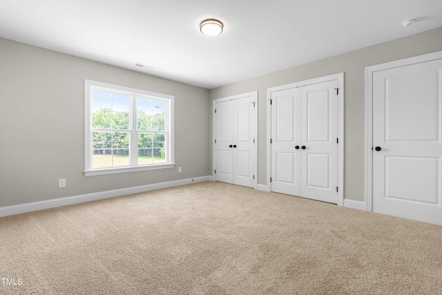 4924 Zebulon Rd, Zebulon, NC 27597 - unfurnished bedroom featuring carpet flooring and multiple closets