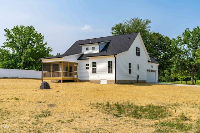 4924 Zebulon Rd, Zebulon, NC 27597 - back of house with a sunroom, a shingled roof, and driveway