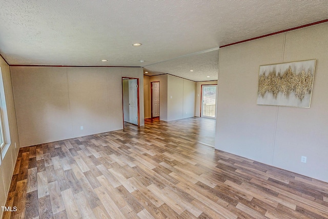 1326 Stephens Dr, Roxboro, NC 27573 - unfurnished room featuring a textured ceiling, wood finished floors, crown molding, and recessed lighting