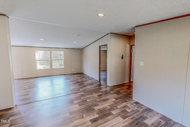 1326 Stephens Dr, Roxboro, NC 27573 - spare room with wood finished floors, a textured ceiling, ornamental molding, and recessed lighting