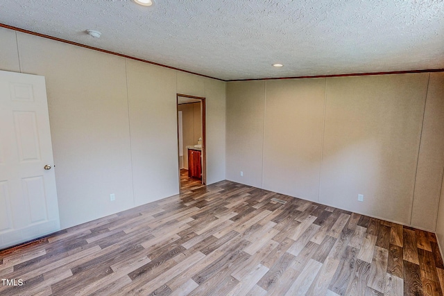 1326 Stephens Dr, Roxboro, NC 27573 - unfurnished room featuring ornamental molding, wood finished floors, a textured ceiling, and recessed lighting