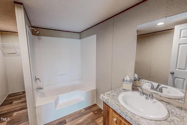 1326 Stephens Dr, Roxboro, NC 27573 - bathroom with wood finished floors, vanity, bathtub / shower combination, a textured ceiling, and crown molding