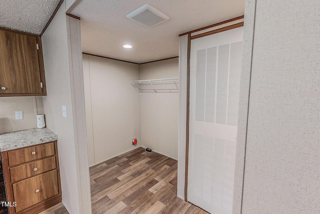 1326 Stephens Dr, Roxboro, NC 27573 - washroom featuring wood finished floors, a heating unit, and a textured ceiling