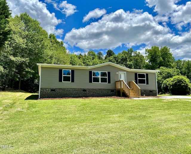 1326 Stephens Dr, Roxboro, NC 27573 - manufactured / mobile home with crawl space, a front lawn, and view of wooded area