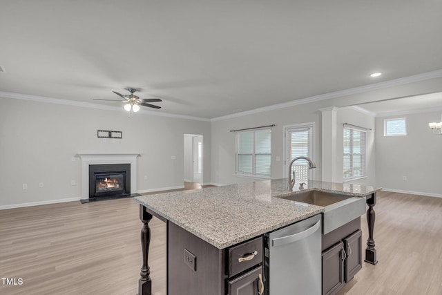 233 Stone River Dr, Wendell, NC 27591 - kitchen featuring open floor plan, ceiling fan with notable chandelier, a sink, dishwasher, and a glass covered fireplace