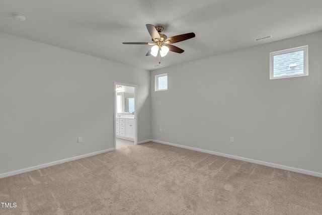 233 Stone River Dr, Wendell, NC 27591 - spare room with baseboards, visible vents, a ceiling fan, and light colored carpet