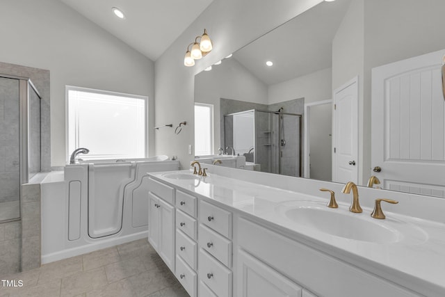 233 Stone River Dr, Wendell, NC 27591 - full bath with vaulted ceiling, a sink, a stall shower, double vanity, and a bath