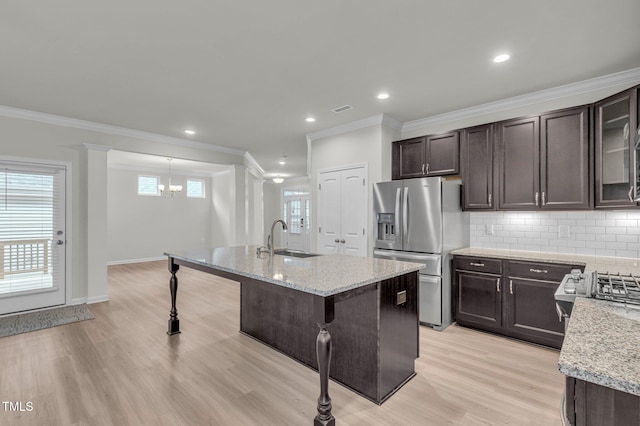 233 Stone River Dr, Wendell, NC 27591 - kitchen with tasteful backsplash, dark brown cabinetry, a sink, stainless steel fridge with ice dispenser, and a kitchen breakfast bar