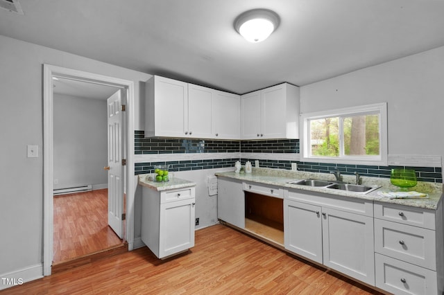 kitchen with a baseboard heating unit, visible vents, light wood finished floors, dishwasher, and a sink